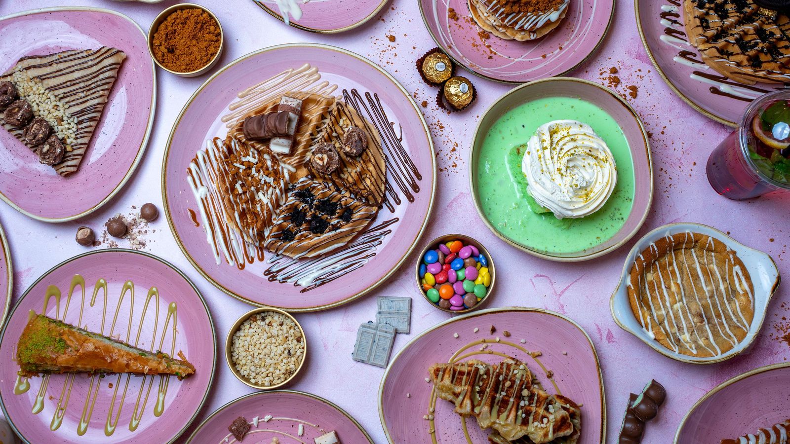 Desserts laid out on pink plates